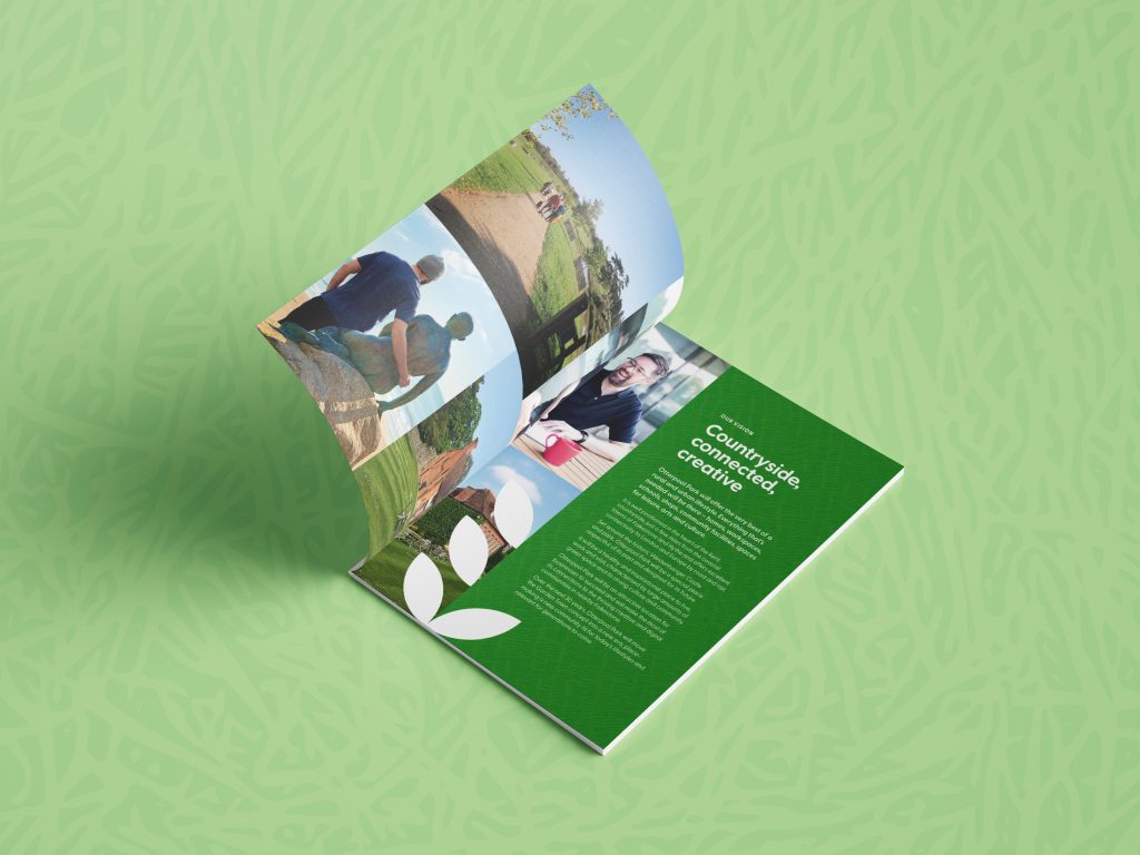 Mockup of an open A4 brochure displaying a spread with aspirational imagery on the left and text on the right with the heading 'Countryside, connected, creative'. 